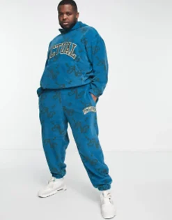 Actual Co-Ord Relaxed Polar Fleece Joggers With All Over Print And Applique Logo In